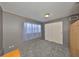 Bedroom featuring a carpeted floor, closet, and a window with translucent curtains at 1520 S Richard Ave, Tampa, FL 33629