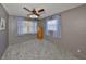 Comfortable bedroom with gray walls, ceiling fan, natural light, and plush gray carpeting at 1520 S Richard Ave, Tampa, FL 33629