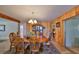 Traditional dining room with wood paneling, chandelier, and dining set with a hutch at 1520 S Richard Ave, Tampa, FL 33629