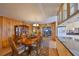 Elegant dining area flowing into the kitchen, featuring wood paneling and ample natural light at 1520 S Richard Ave, Tampa, FL 33629
