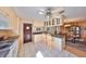 Bright kitchen featuring white appliances, stone countertops, and a view into the dining area at 1520 S Richard Ave, Tampa, FL 33629