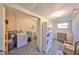 Utility room with laundry area, shelving, water heater, and ample space at 1520 S Richard Ave, Tampa, FL 33629