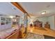 Inviting basement area with dining room view, wood-look flooring, exposed beam, and brick pillar at 1520 S Richard Ave, Tampa, FL 33629