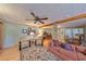 Cozy finished basement featuring wood flooring, exposed beams, comfortable seating, and accent wall at 1520 S Richard Ave, Tampa, FL 33629