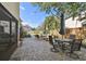 Spacious brick patio ideal for entertaining with multiple seating areas and views of the fenced backyard at 19 Sandpiper Rd, Tampa, FL 33609
