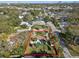 Aerial view of a home featuring lush landscaping, a circular driveway, and a sparkling private pool in a quiet neighborhood at 1905 S Hesperides St, Tampa, FL 33629