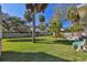 Picture of a wide backyard with mature trees, lush green lawn and privacy fence at 1905 S Hesperides St, Tampa, FL 33629