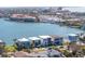 An aerial view of luxury waterfront homes with docks, set against a backdrop of a charming coastal city at 201 Punta Vista Dr, St Pete Beach, FL 33706