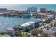 Waterfront homes with boat docks line a scenic canal, with ocean views and city skyline in the distance at 201 Punta Vista Dr, St Pete Beach, FL 33706