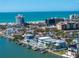 An aerial view showcases stunning waterfront homes, a pristine beach, and oceanfront condos at 201 Punta Vista Dr, St Pete Beach, FL 33706