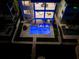 Aerial view of a luxury home with a pool, spa, and outdoor living spaces, illuminated at night at 201 Punta Vista Dr, St Pete Beach, FL 33706