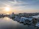 Stunning aerial view of waterfront homes, docks, and boat lifts on a sunny day at 201 Punta Vista Dr, St Pete Beach, FL 33706