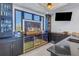 Wet bar featuring dark cabinetry, wine fridge, liquor display, and marble backsplash at 201 Punta Vista Dr, St Pete Beach, FL 33706