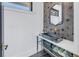Modern powder room featuring black sink, gold faucet, and bold hexagon tile accent wall at 201 Punta Vista Dr, St Pete Beach, FL 33706