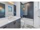 This bathroom offers a sleek vanity, gold hardware, and tiled shower and tub at 201 Punta Vista Dr, St Pete Beach, FL 33706
