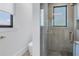 This bathroom offers a glass shower enclosure with herringbone tile and a window at 201 Punta Vista Dr, St Pete Beach, FL 33706