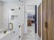 Modern bathroom features a glass shower, marble floors, and access to the spacious walk-in closet at 201 Punta Vista Dr, St Pete Beach, FL 33706