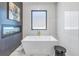 This modern bathroom offers a luxury bathtub, fireplace, and elegant tile at 201 Punta Vista Dr, St Pete Beach, FL 33706