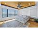 This bright bedroom features panoramic water views and neutral color palette at 201 Punta Vista Dr, St Pete Beach, FL 33706
