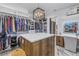 Well-organized walk-in closet with custom storage, center island, vanity, and recessed lighting at 201 Punta Vista Dr, St Pete Beach, FL 33706