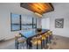 Bright dining room features a modern chandelier, table with seating for six, and a beautiful water view at 201 Punta Vista Dr, St Pete Beach, FL 33706