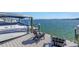 Waterfront dock featuring modern boat lifts, mooring pilings, and a relaxing seating area at 201 Punta Vista Dr, St Pete Beach, FL 33706