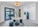 Airy foyer with a modern table, and a sliding glass door leading to an outdoor view at 201 Punta Vista Dr, St Pete Beach, FL 33706