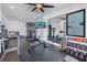 Well-equipped home gym with modern exercise machines, free weights, and a mounted television at 201 Punta Vista Dr, St Pete Beach, FL 33706