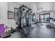 Bright home gym features state-of-the-art exercise equipment and water views at 201 Punta Vista Dr, St Pete Beach, FL 33706