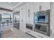 Kitchen featuring white cabinets, stainless steel appliances and view of dining area at 201 Punta Vista Dr, St Pete Beach, FL 33706