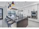 Bright kitchen with island featuring bar stool seating, dark countertops and stainless appliances at 201 Punta Vista Dr, St Pete Beach, FL 33706