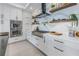 Modern kitchen showcasing quartz countertops, gas cooktop, and stainless steel double ovens at 201 Punta Vista Dr, St Pete Beach, FL 33706