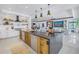 Spacious kitchen featuring white cabinets, wood accents, and stainless appliances at 201 Punta Vista Dr, St Pete Beach, FL 33706