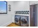 This laundry room boasts modern appliances, white cabinetry, and geometric backsplash at 201 Punta Vista Dr, St Pete Beach, FL 33706