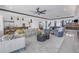 Open-concept living room with modern furnishings, adjacent to a kitchen and bar area at 201 Punta Vista Dr, St Pete Beach, FL 33706