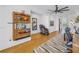 Home office area with custom shelving, a massage chair, and hardwood flooring at 201 Punta Vista Dr, St Pete Beach, FL 33706
