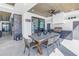 Covered outdoor dining area with built-in grill and access to the pool area at 201 Punta Vista Dr, St Pete Beach, FL 33706