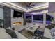 Covered outdoor living space with fireplace, TV, plush seating, pool and waterfront views at 201 Punta Vista Dr, St Pete Beach, FL 33706