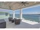 Relaxing covered patio with ceiling fans offering views of the waterfront at 201 Punta Vista Dr, St Pete Beach, FL 33706