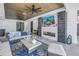 Inviting covered patio with fireplace, tv, and comfortable wicker furniture at 201 Punta Vista Dr, St Pete Beach, FL 33706