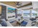 Beautiful covered patio with stone fireplace, comfortable seating, and waterfront views at 201 Punta Vista Dr, St Pete Beach, FL 33706
