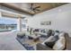 Relaxing covered patio with waterfront view, wicker seating and stylish blue rug at 201 Punta Vista Dr, St Pete Beach, FL 33706