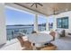 Waterfront patio with seating offering stunning views of the bay and boat dock at 201 Punta Vista Dr, St Pete Beach, FL 33706