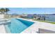 A stunning swimming pool with spa offers beautiful waterfront views of the canal and docks at 201 Punta Vista Dr, St Pete Beach, FL 33706