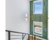 Modern staircase featuring geometric green accent wall and an abundance of natural light at 201 Punta Vista Dr, St Pete Beach, FL 33706