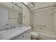 Bathroom with marble countertop, a wide mirror, and a shower-tub combo with tiled walls at 2224 Vista Royal Way, Spring Hill, FL 34606