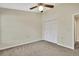 Neutral bedroom with carpeted floors, ceiling fan, and a closet for storage at 2224 Vista Royal Way, Spring Hill, FL 34606