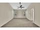 Neutral bedroom with carpeted floors, ceiling fan, and natural light from the windows at 2224 Vista Royal Way, Spring Hill, FL 34606