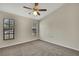 Bedroom featuring neutral walls, carpet flooring, ceiling fan and two windows for natural lighting at 2224 Vista Royal Way, Spring Hill, FL 34606