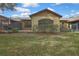The home with a patio and a grassy backyard at 2224 Vista Royal Way, Spring Hill, FL 34606